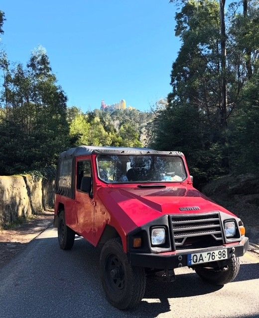 Red jeep below Pena Palace